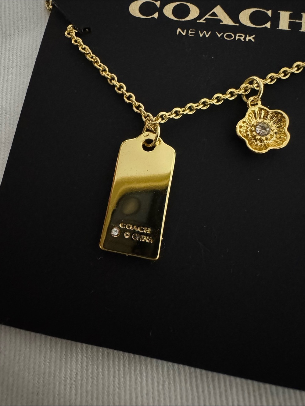 Coach Gold-Tone Logo Tag and Flower Charm Necklace - Picture 4 of 7